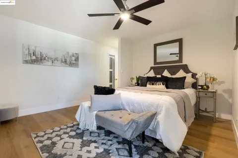 a bedroom with a bed and wooden floor