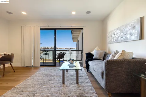 a living room with furniture a rug and a table
