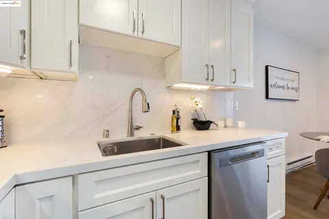 a kitchen with a sink cabinets and a window