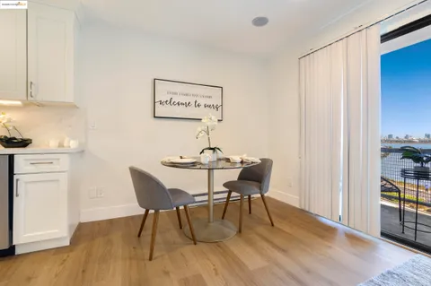 a dining room with furniture and wooden floor