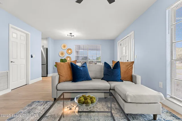 a living room with furniture and wooden floor