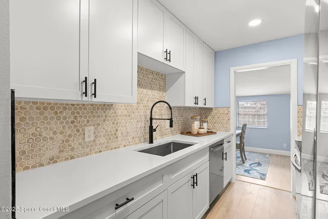 a kitchen with a sink and a refrigerator