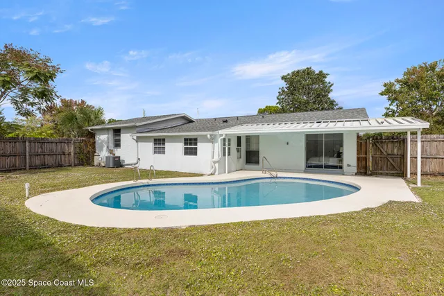 an aerial view of a house with a swimming pool