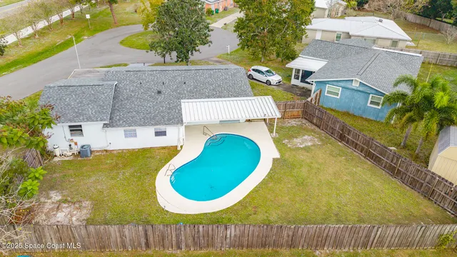 an aerial view of a house with swimming pool