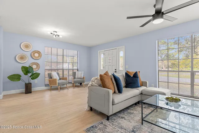 a living room with furniture and wooden floor