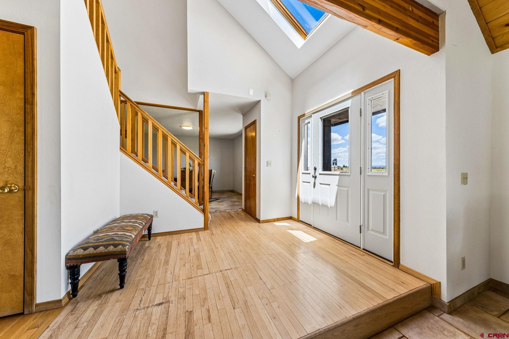 22480 Rd L Cortez, CO 81321 - Photo 2 of 44 a view of a hallway with wooden floor and staircase