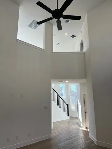 a view of a hallway with wooden floor and staircase