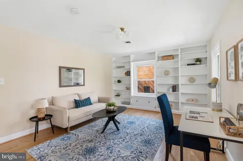 a living room with furniture and a rug