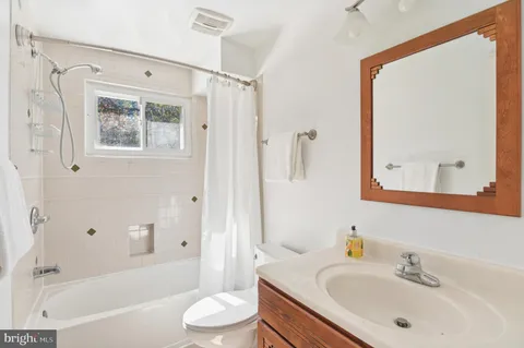 a bathroom with a sink a toilet and a bathtub