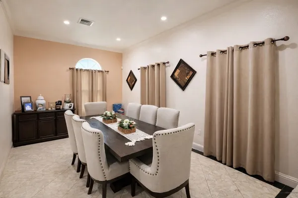 a dining room with furniture and a window