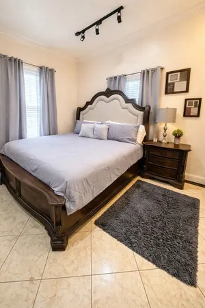 a bedroom with bed and window