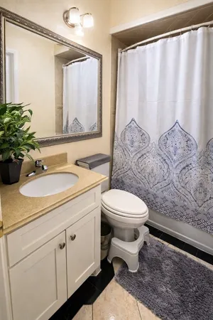 a bathroom with a toilet sink and mirror