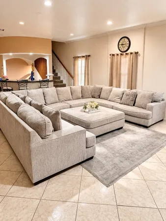 a living room with furniture a rug and a fireplace