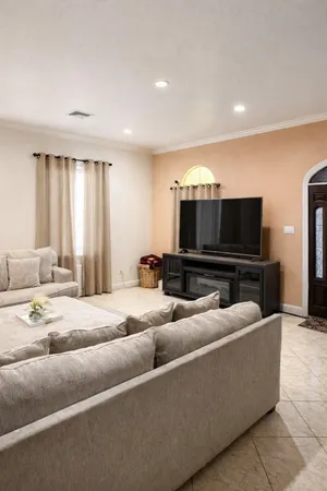 a living room with furniture and a flat screen tv