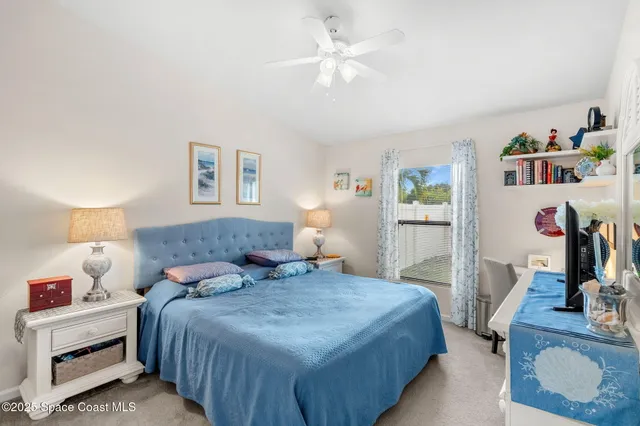 a bedroom with a bed and a dresser with the shoe rack