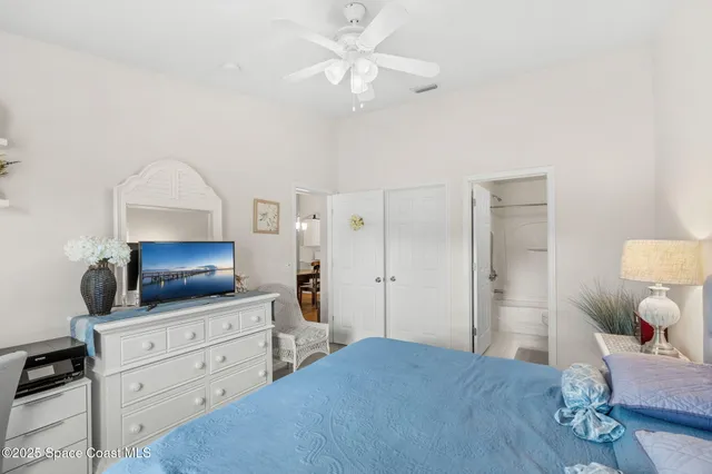 a bedroom with a bed and a dresser in it