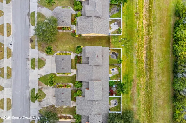an aerial view of residential houses with outdoor space