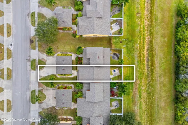 an aerial view of houses with swimming pool