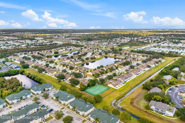 an aerial view of residential building and ocean
