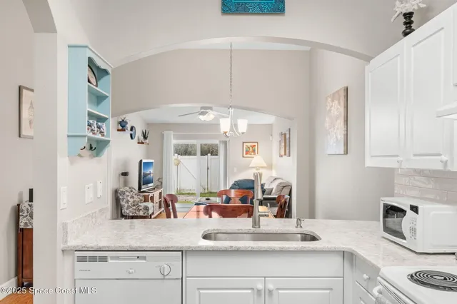 a kitchen with stainless steel appliances granite countertop a sink and cabinets
