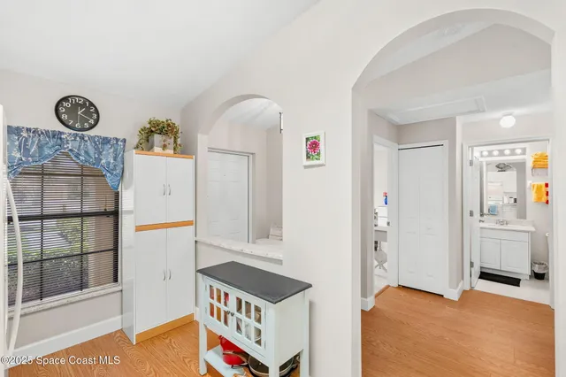 a storage room with cabinets and wooden floor