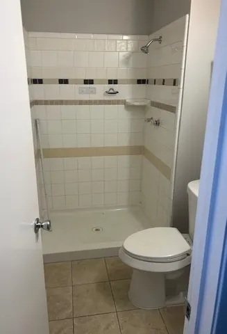 a bathroom with a toilet and a shower