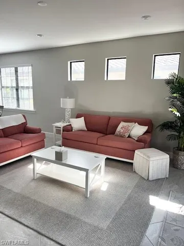 a living room with furniture and a potted plant