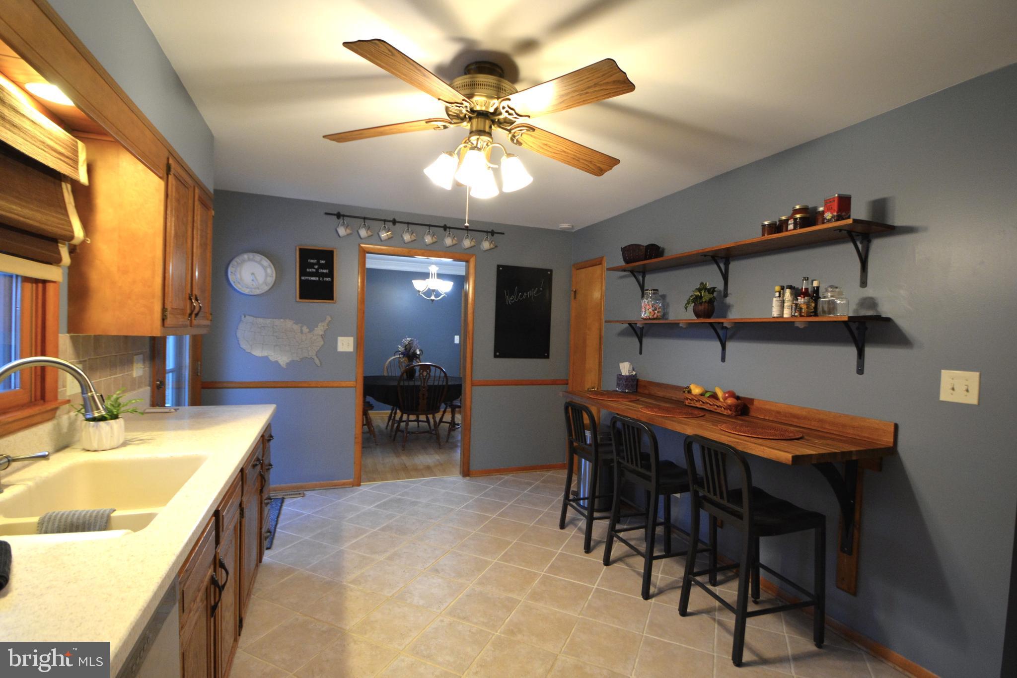 1658 Sams Creek Road Westminster, MD 21157 - Photo 12 of 59 a view of a dining room with furniture and chandelier fan