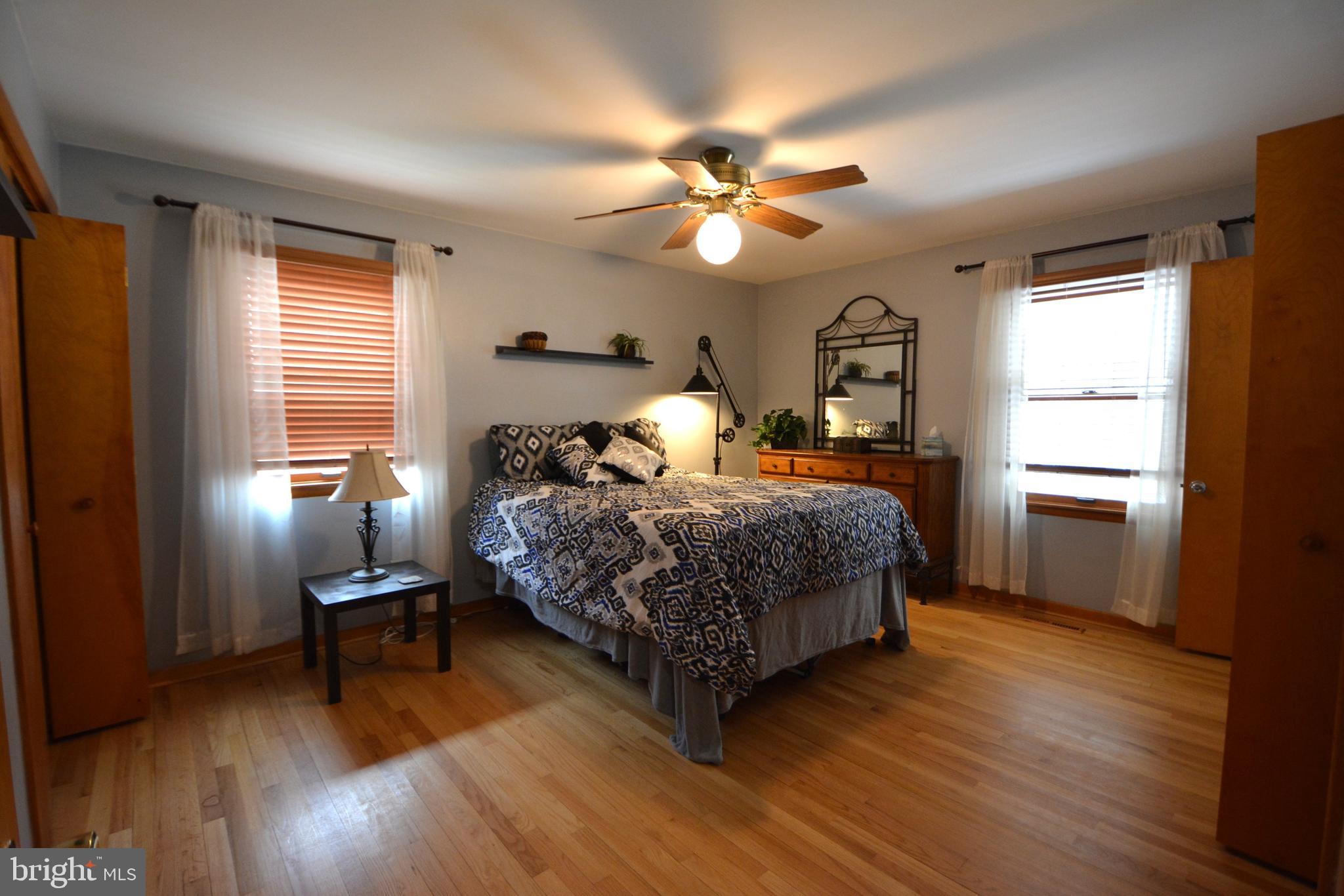 1658 Sams Creek Road Westminster, MD 21157 - Photo 18 of 59 a bedroom with a bed and wooden floor