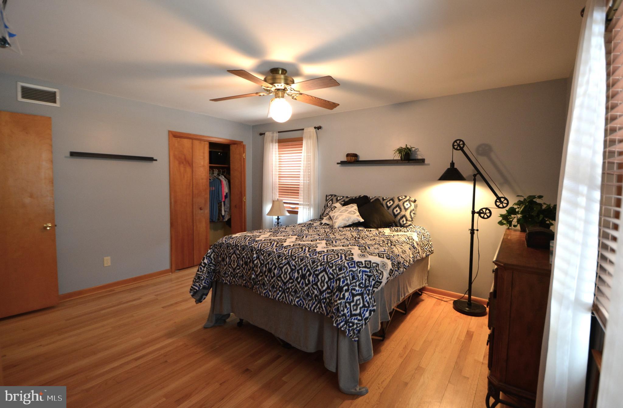 1658 Sams Creek Road Westminster, MD 21157 - Photo 19 of 59 a bedroom with a bed and a chandelier