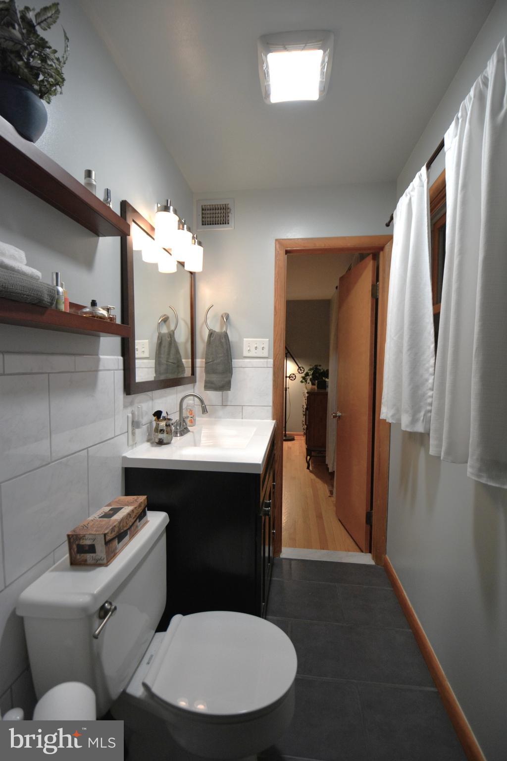 1658 Sams Creek Road Westminster, MD 21157 - Photo 22 of 59 a bathroom with a toilet sink and mirror