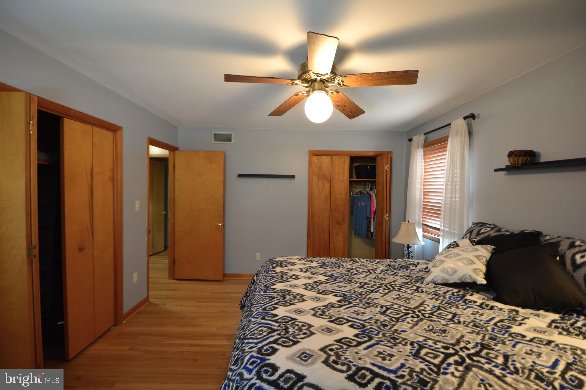 1658 Sams Creek Road Westminster, MD 21157 - Photo 23 of 59 a bedroom with a bed and a chandelier