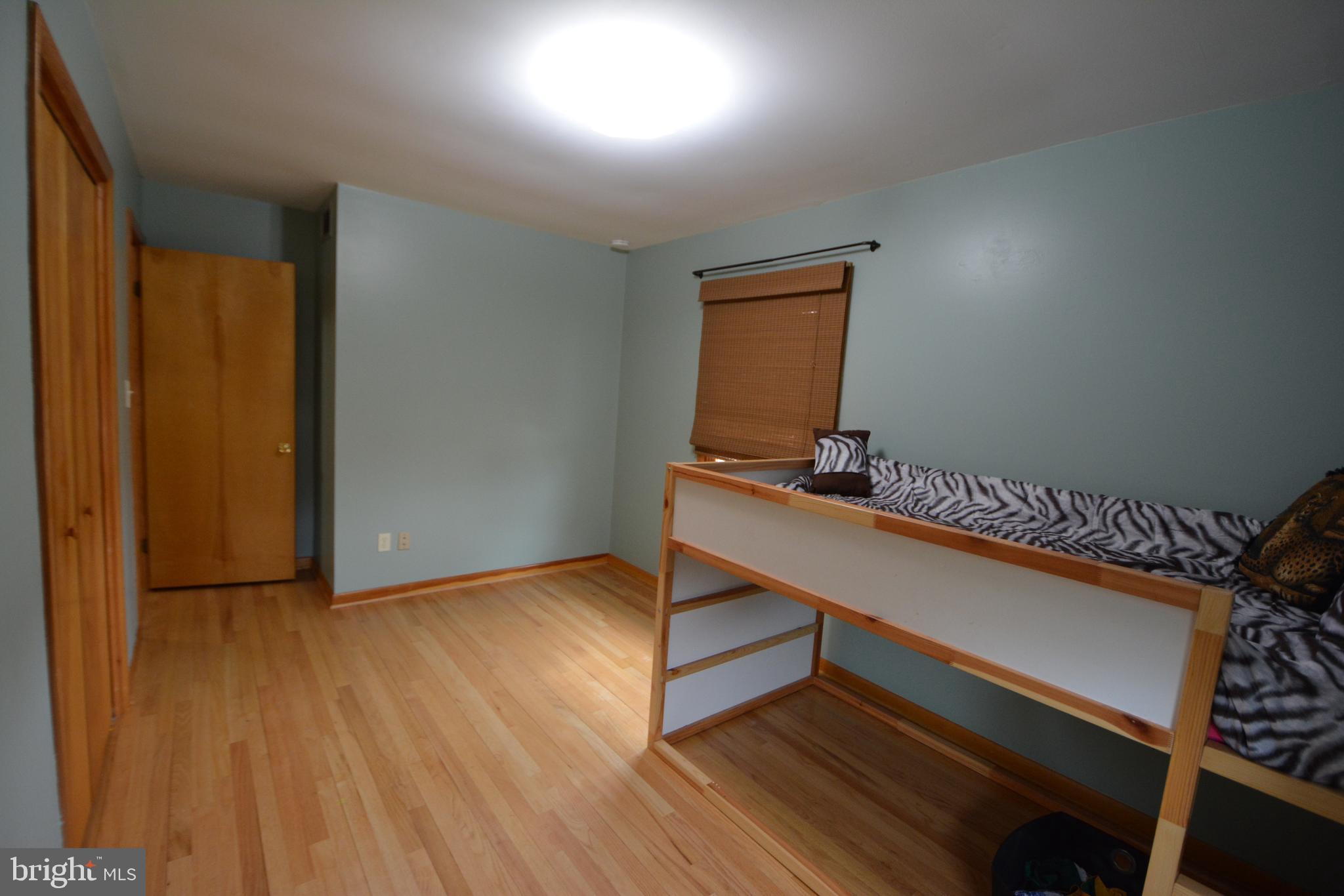 1658 Sams Creek Road Westminster, MD 21157 - Photo 26 of 59 a room with wooden floor and furniture