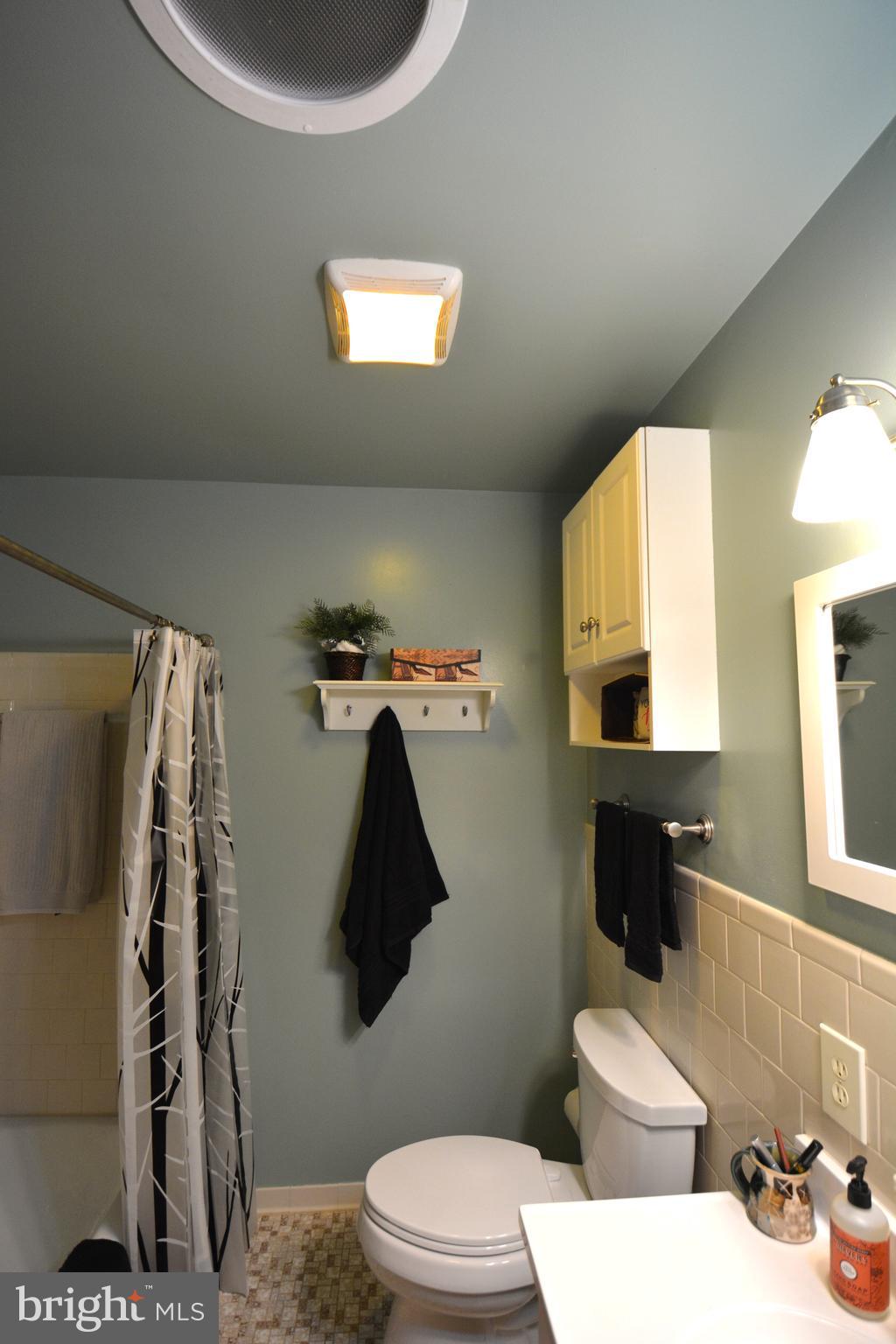 1658 Sams Creek Road Westminster, MD 21157 - Photo 30 of 59 a bathroom with a toilet sink and mirror