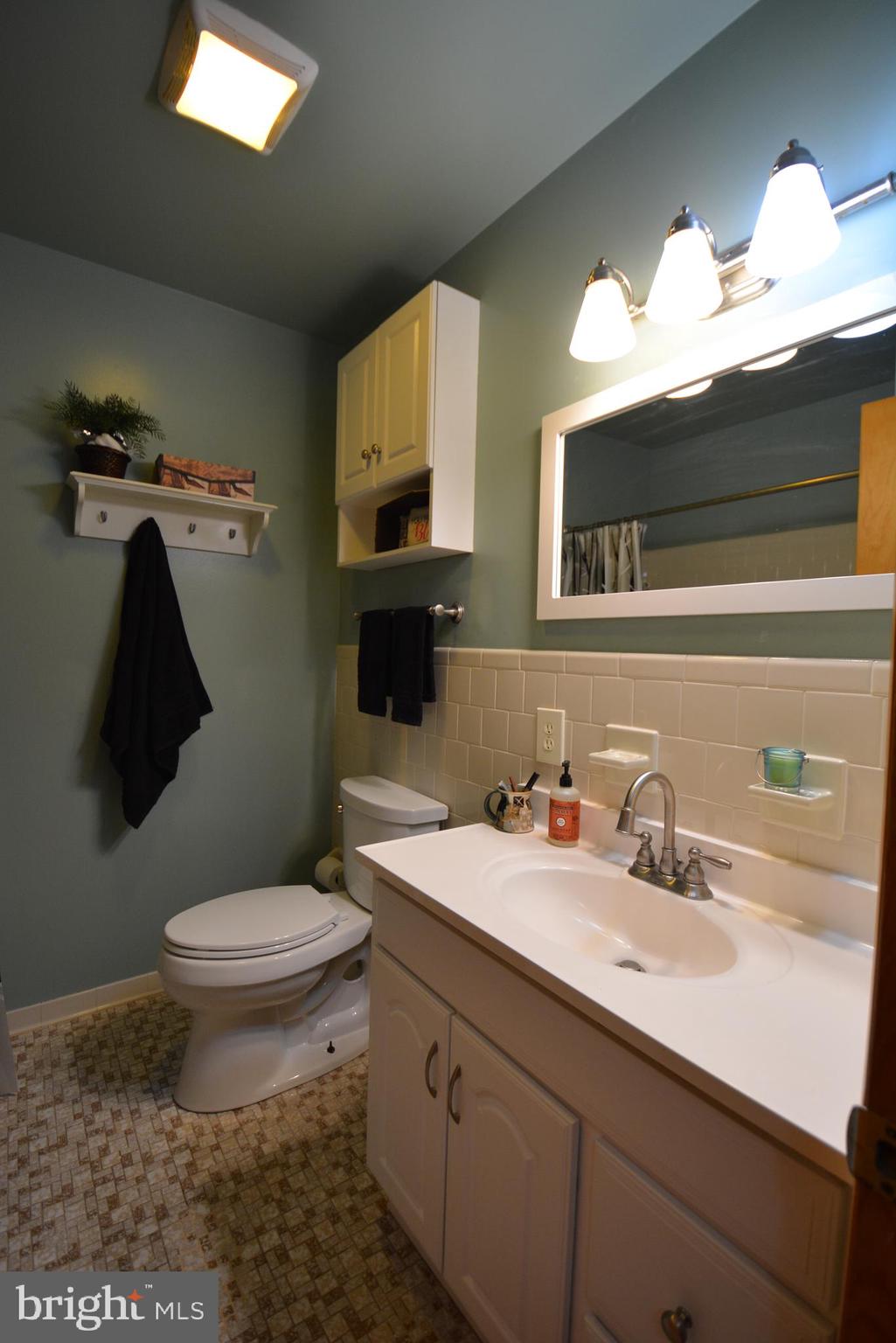 1658 Sams Creek Road Westminster, MD 21157 - Photo 31 of 59 a bathroom with a sink and a mirror