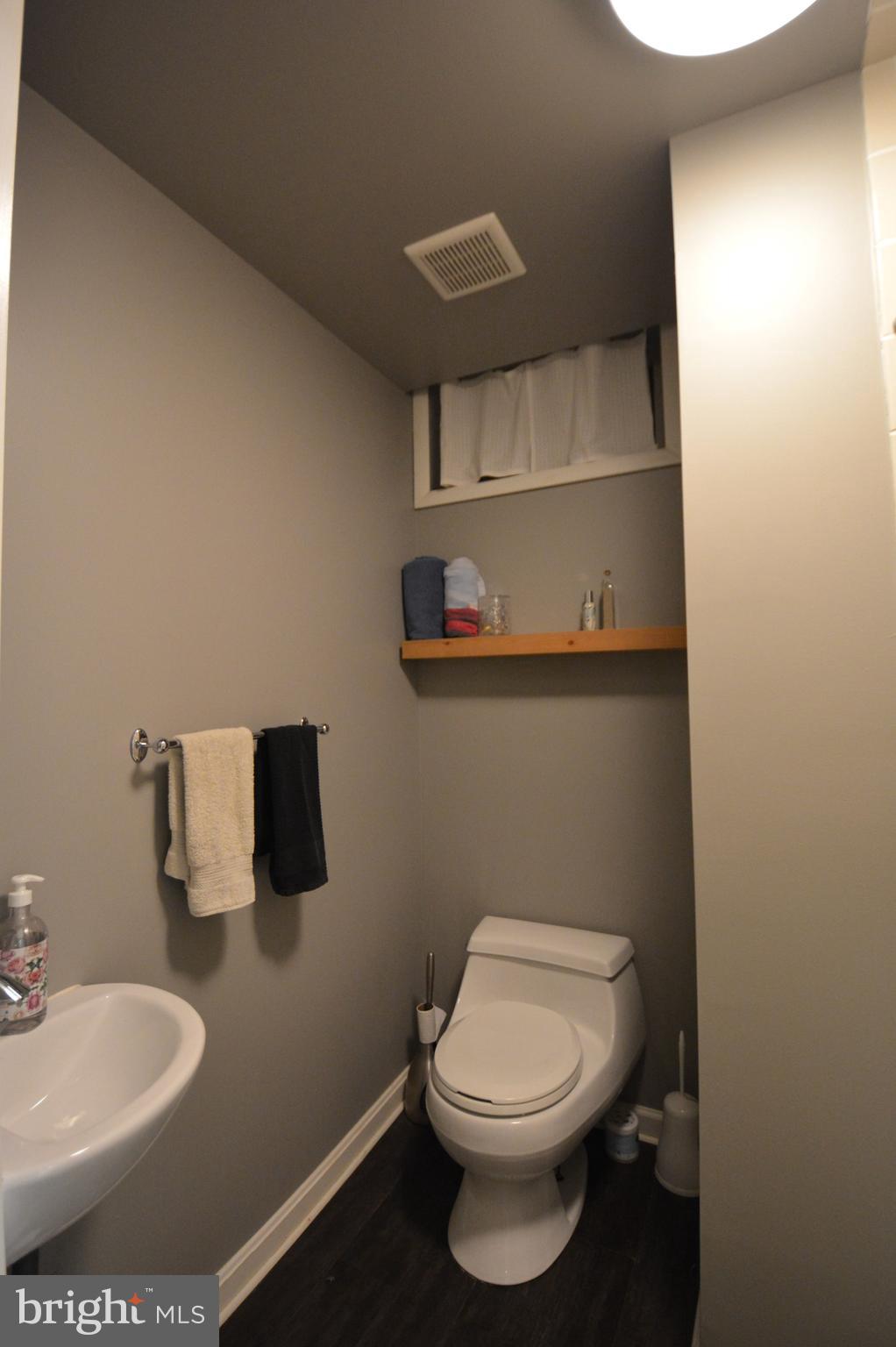 1658 Sams Creek Road Westminster, MD 21157 - Photo 45 of 59 a bathroom with a toilet a sink and mirror