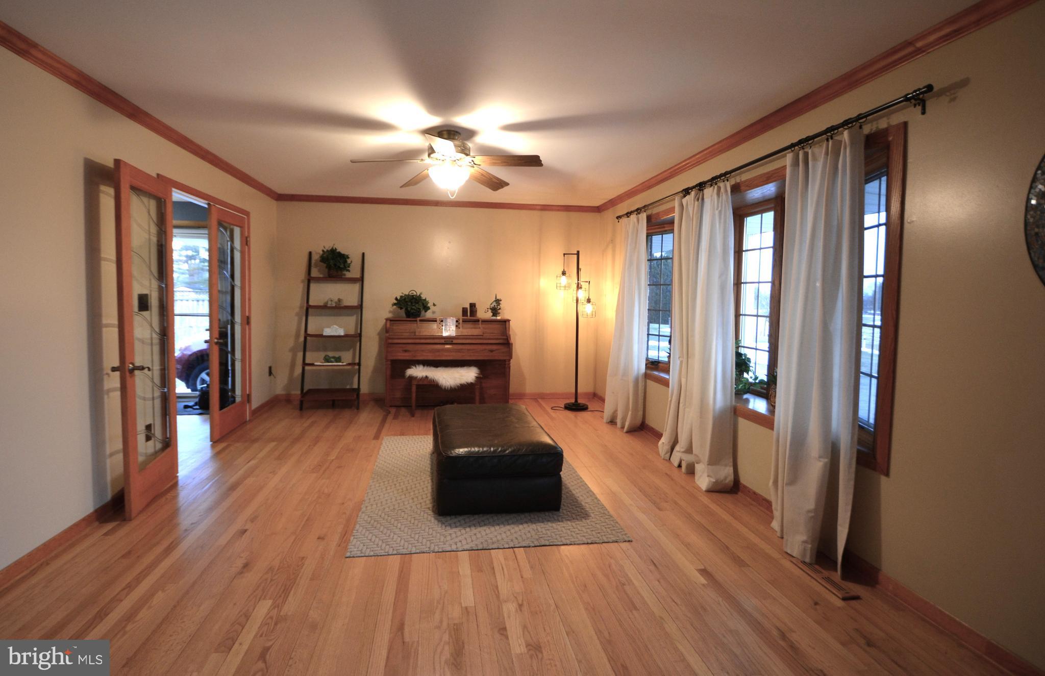 1658 Sams Creek Road Westminster, MD 21157 - Photo 7 of 59 a living room with furniture and a wooden floor