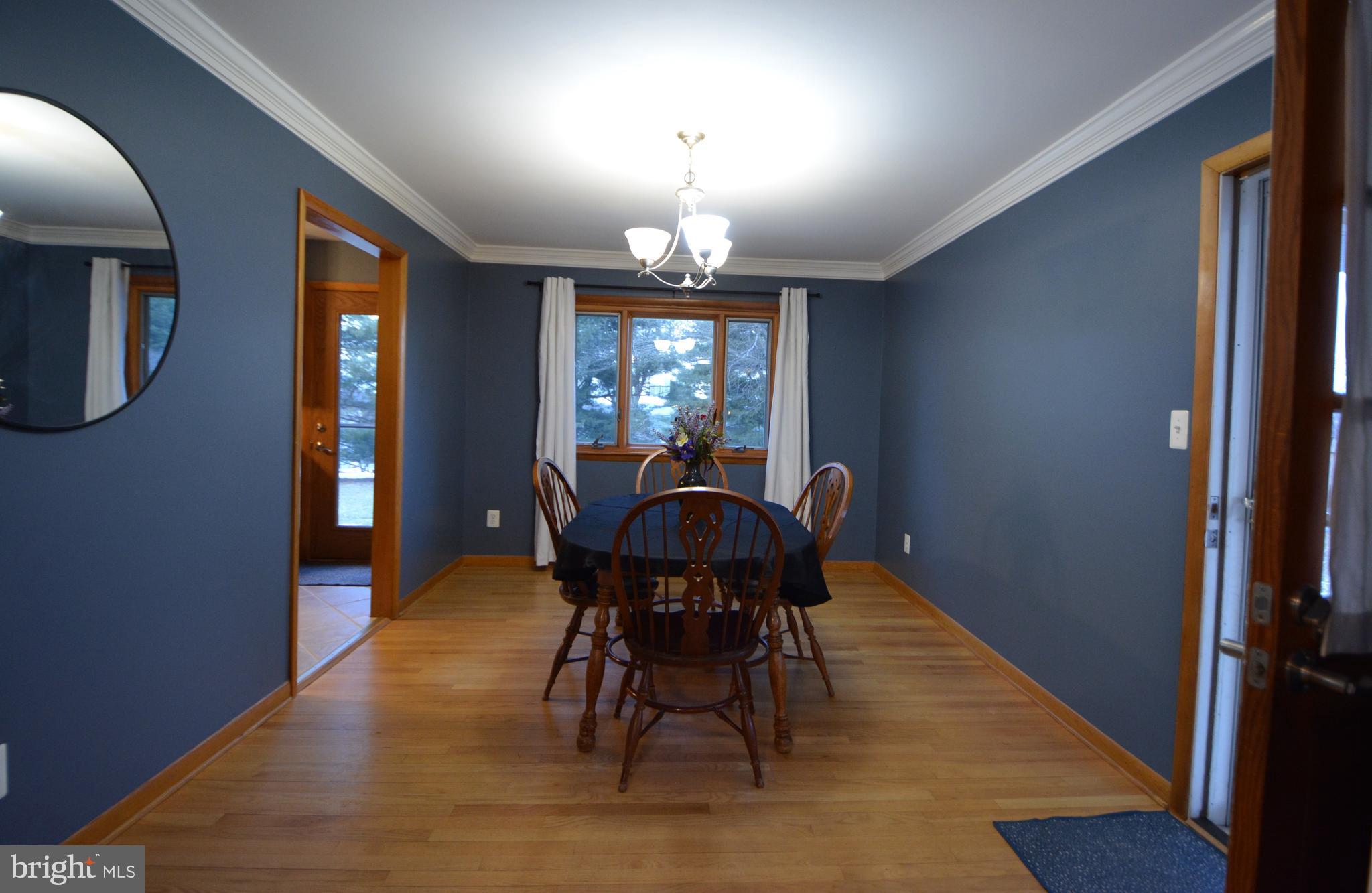 1658 Sams Creek Road Westminster, MD 21157 - Photo 8 of 59 a view of a dining room with furniture and wooden floor