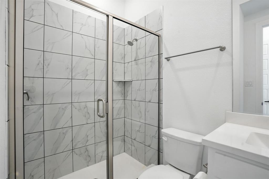 4621 Mount Vista Road Oak Point, TX 75068 - Photo 31 of 40 a bathroom with a toilet and a shower