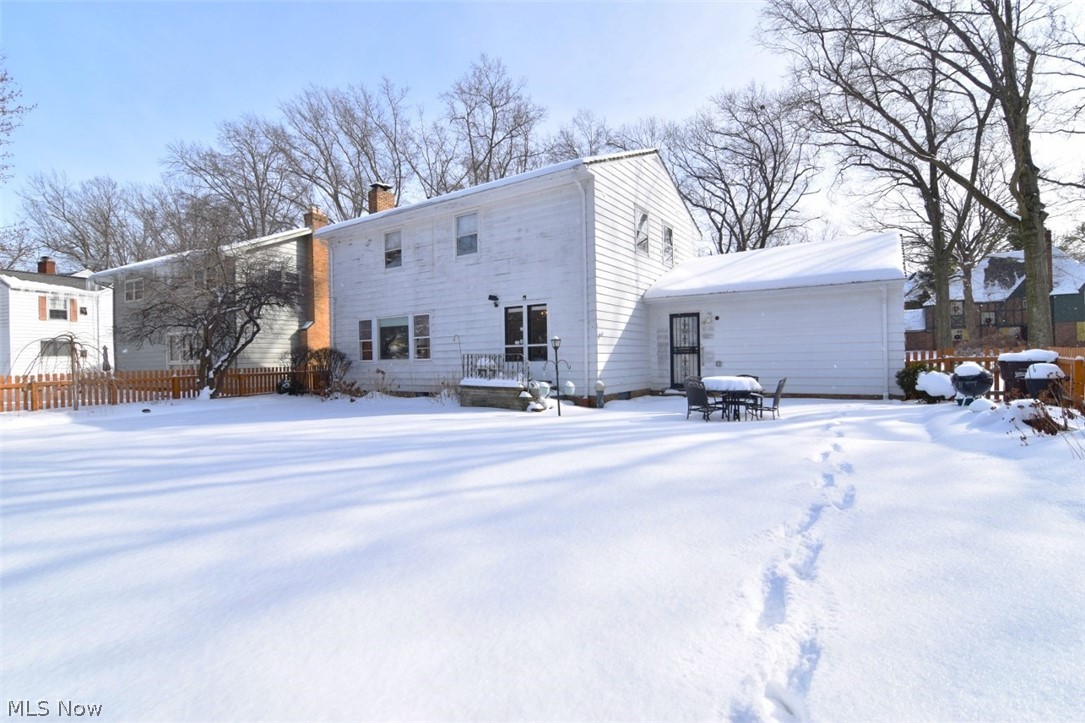 15991 Henley Road Cleveland, OH 44112 - Photo 35 of 36 Snow covered back of property featuring a chimney and a patio area