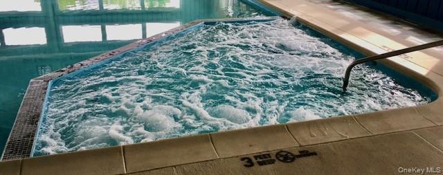 302 Commons Way, Unit E Fishkill, NY 12524 - Photo 22 of 26 View of pool featuring an in-ground hot tub and a pool