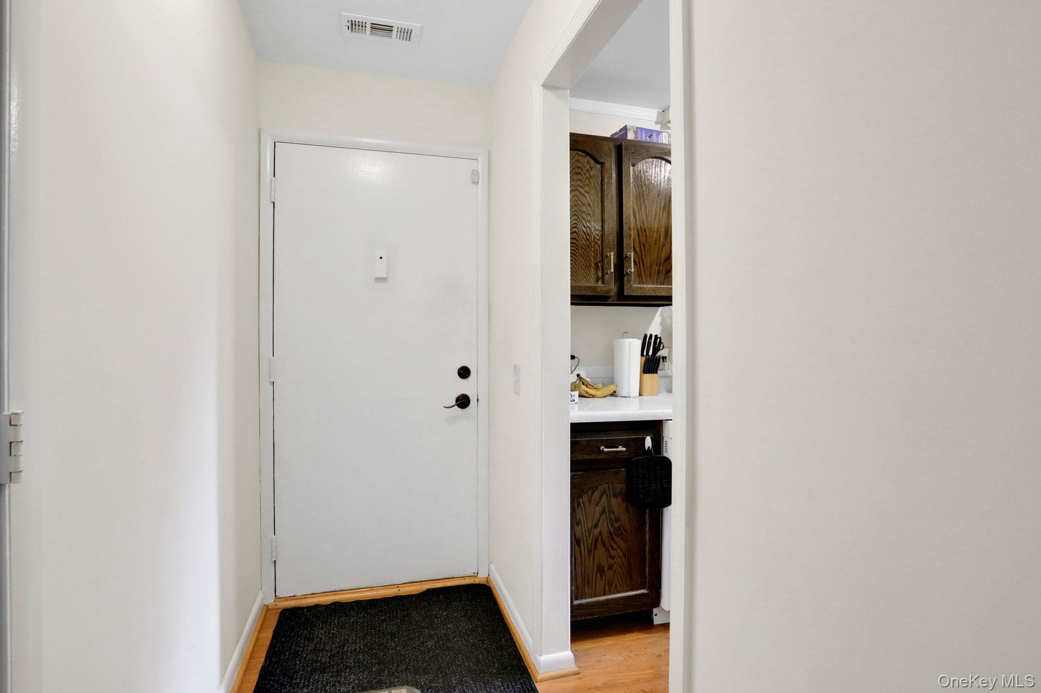 302 Commons Way, Unit E Fishkill, NY 12524 - Photo 5 of 26 Doorway to outside with wood finished floors and baseboards