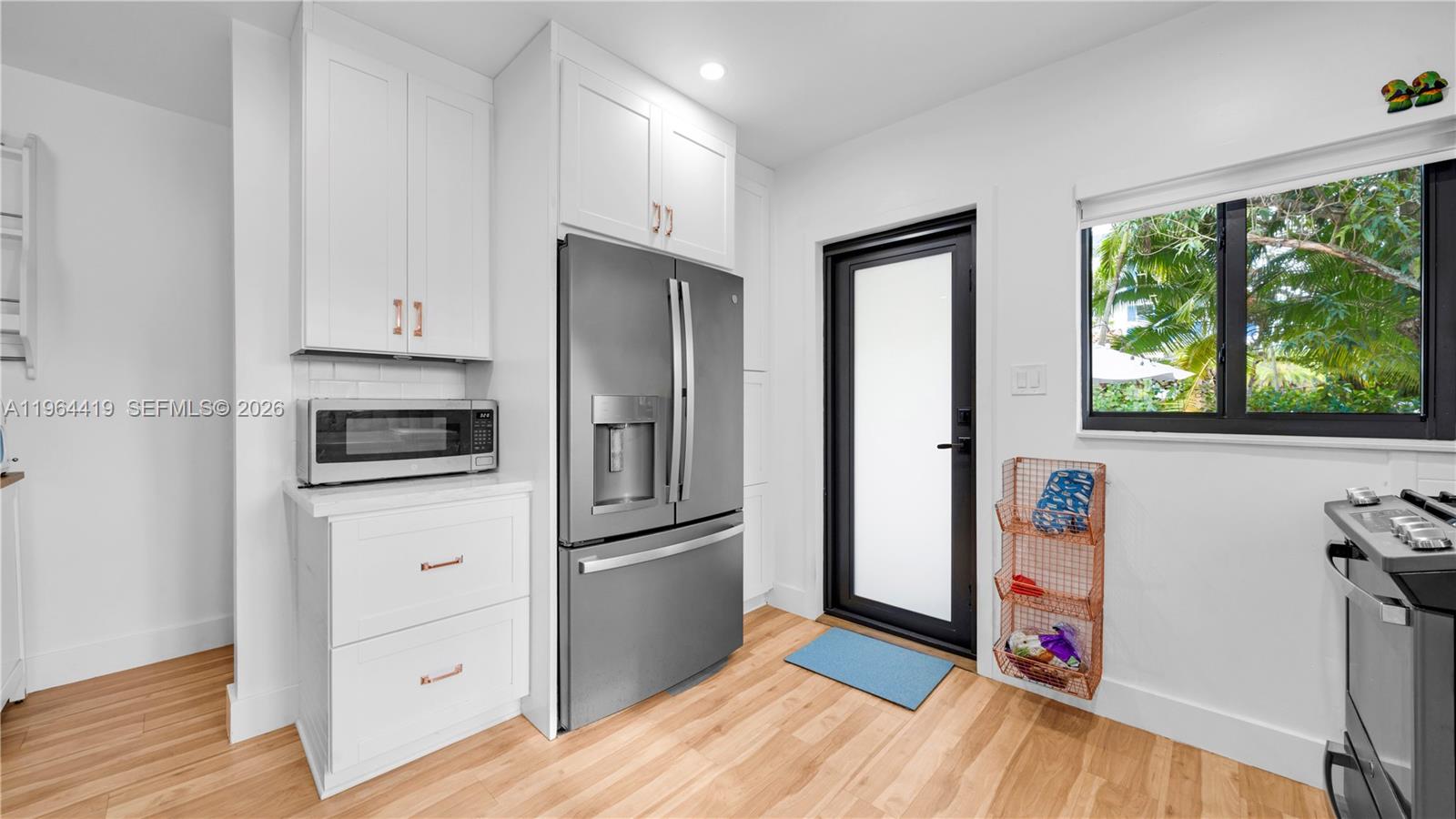 375 Southwest 32nd Road Miami, FL 33129 - Photo 12 of 39 a kitchen with stainless steel appliances a refrigerator sink and wooden floor