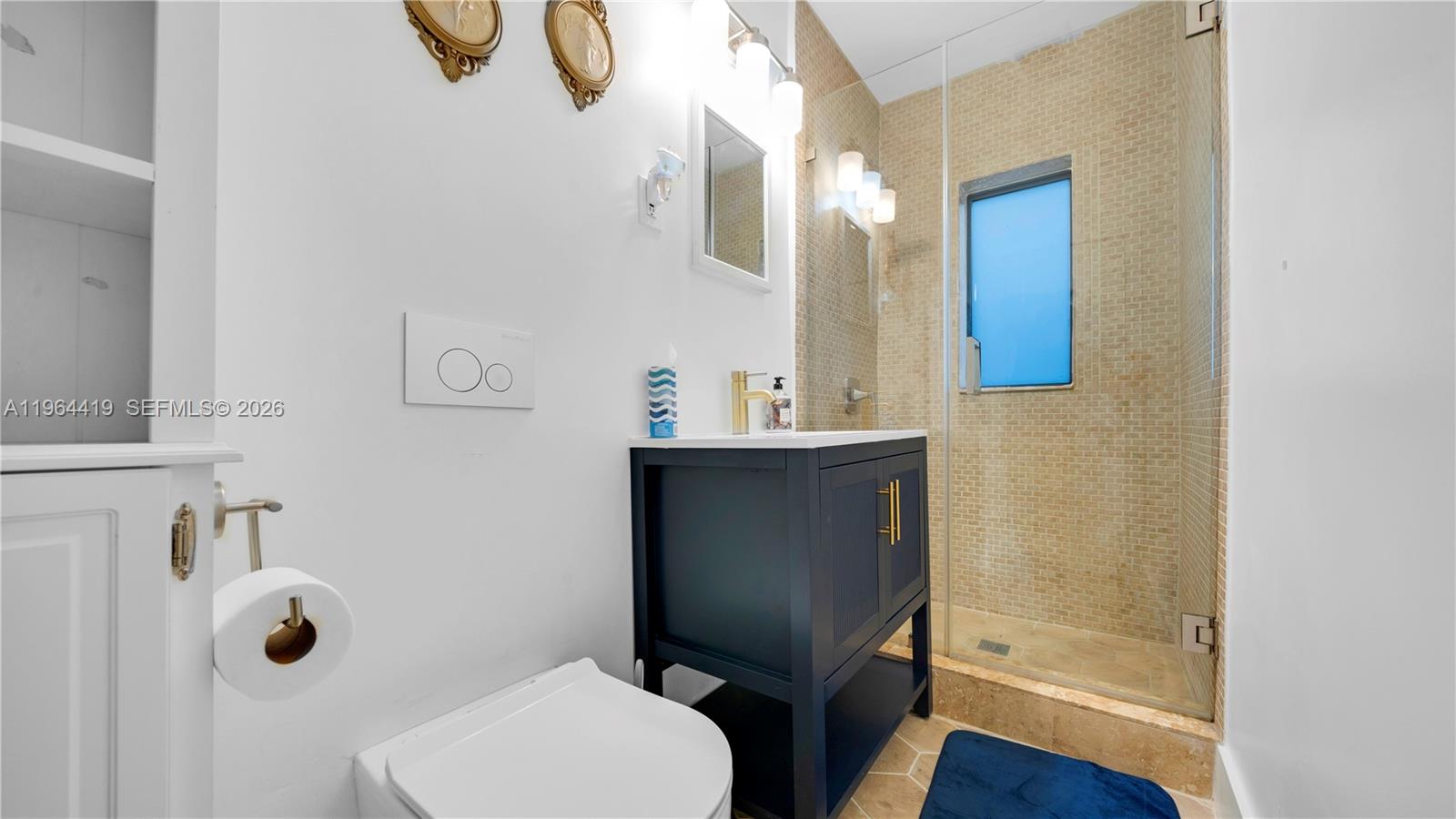 375 Southwest 32nd Road Miami, FL 33129 - Photo 22 of 39 a bathroom with a toilet and a sink