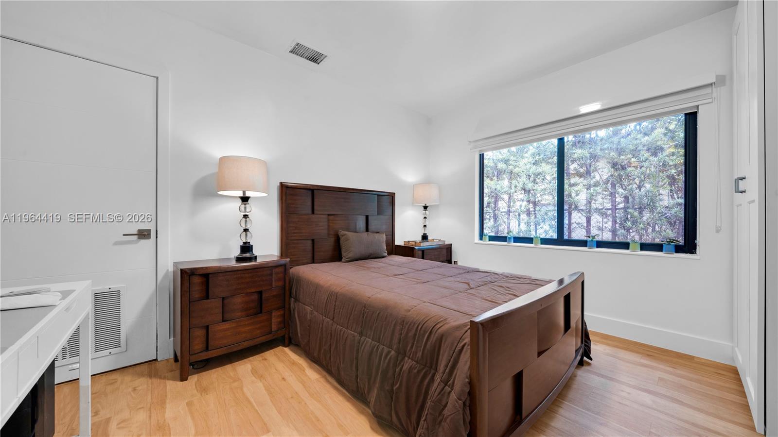 375 Southwest 32nd Road Miami, FL 33129 - Photo 23 of 39 a bedroom with a bed and a dresser next to a window