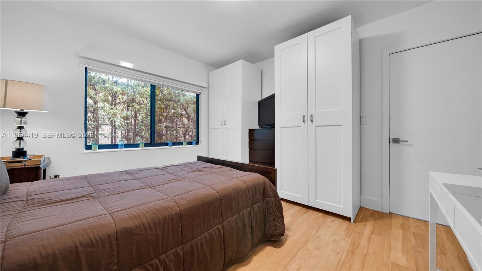 375 Southwest 32nd Road Miami, FL 33129 - Photo 24 of 39 a bedroom with a bed and a large window