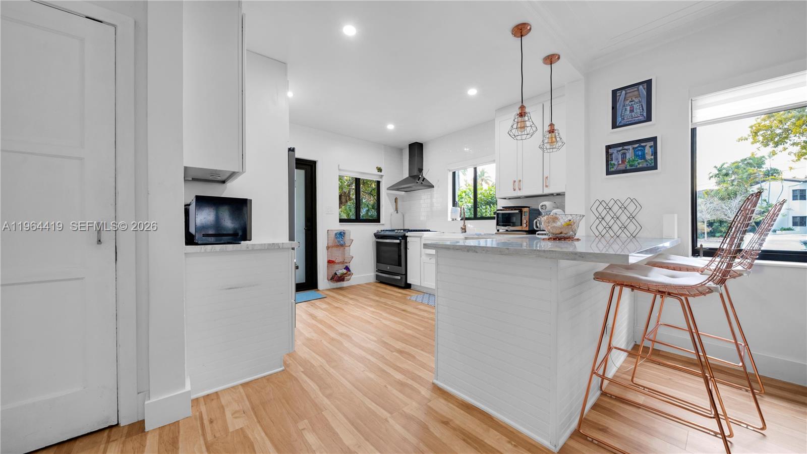 375 Southwest 32nd Road Miami, FL 33129 - Photo 25 of 39 a living room with stainless steel appliances kitchen island granite countertop furniture and a wooden floor