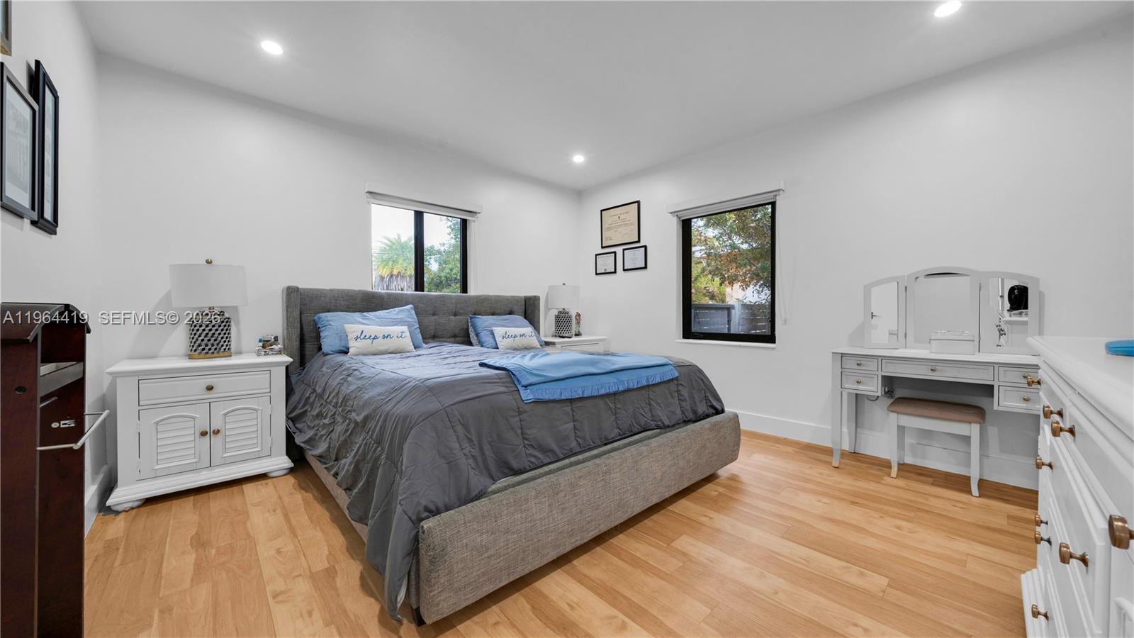 375 Southwest 32nd Road Miami, FL 33129 - Photo 26 of 39 a bedroom with a bed and dresser with wooden floor