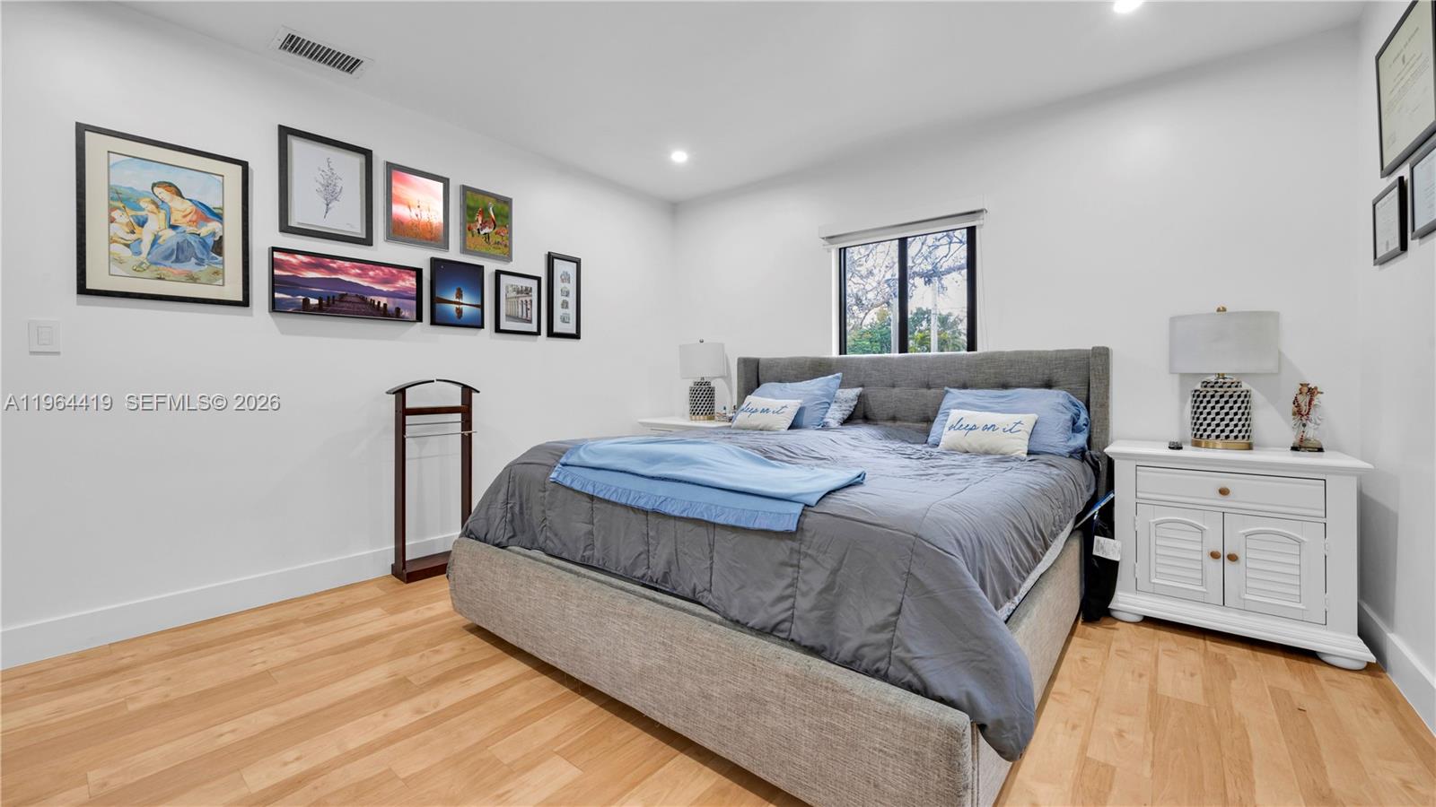 375 Southwest 32nd Road Miami, FL 33129 - Photo 27 of 39 a bedroom with a bed and a painting on the wall