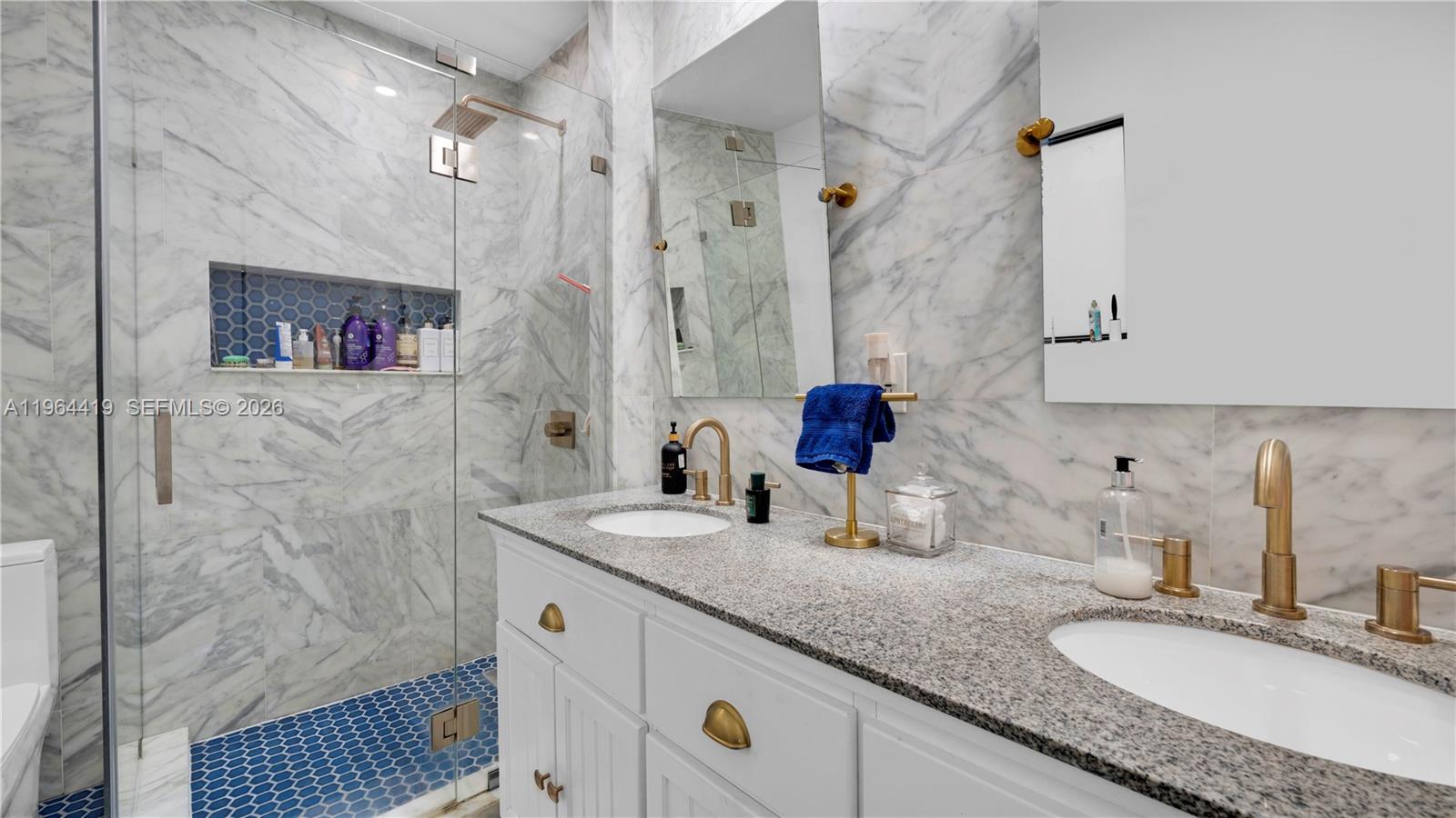 375 Southwest 32nd Road Miami, FL 33129 - Photo 29 of 39 a bathroom with double vanity sink a mirror and shower